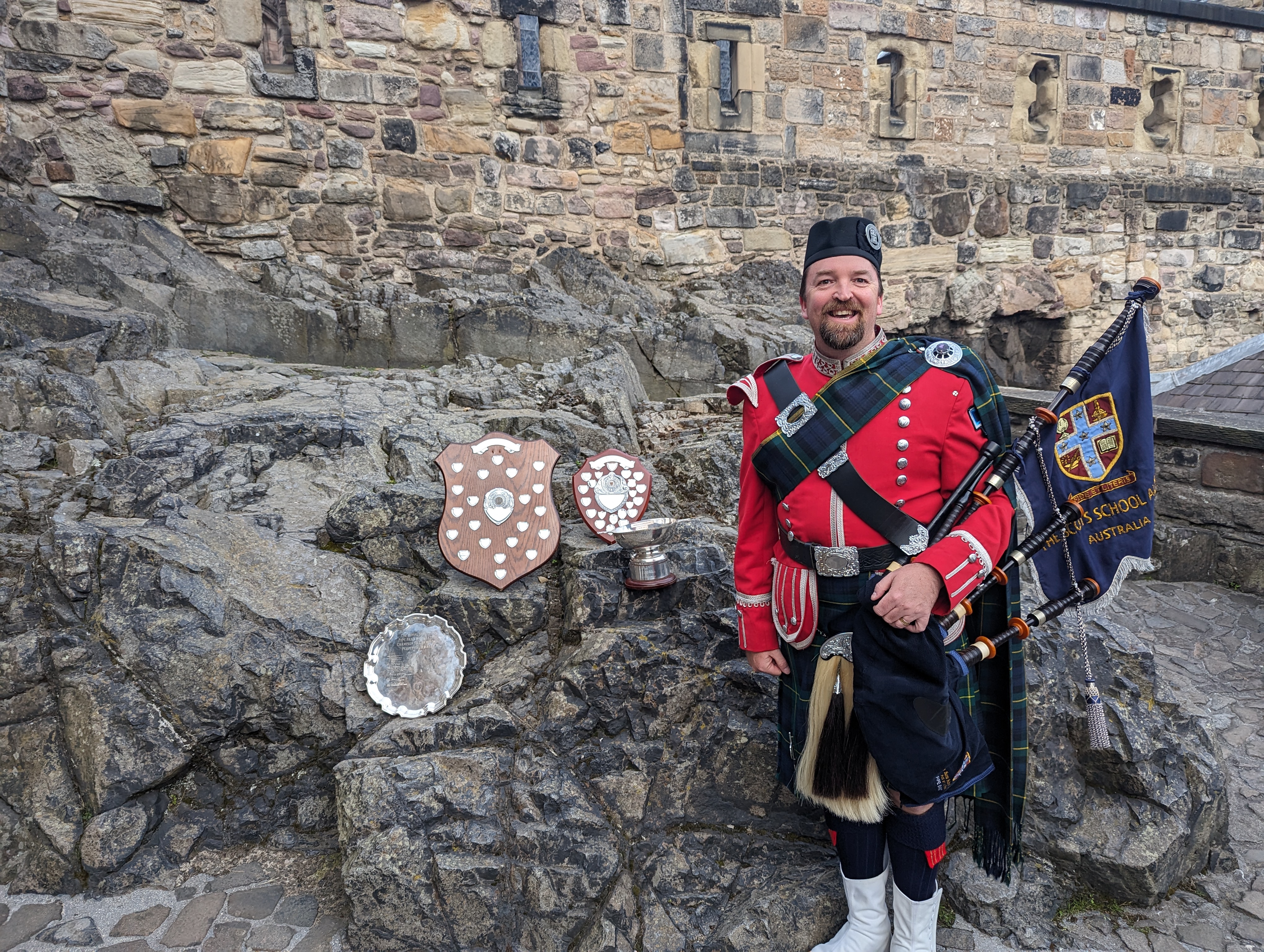 Angus Beath at Edinburgh Castle with the World Champion and Champion of Champions shields, Royal Edinburgh Military Tattoo 2023